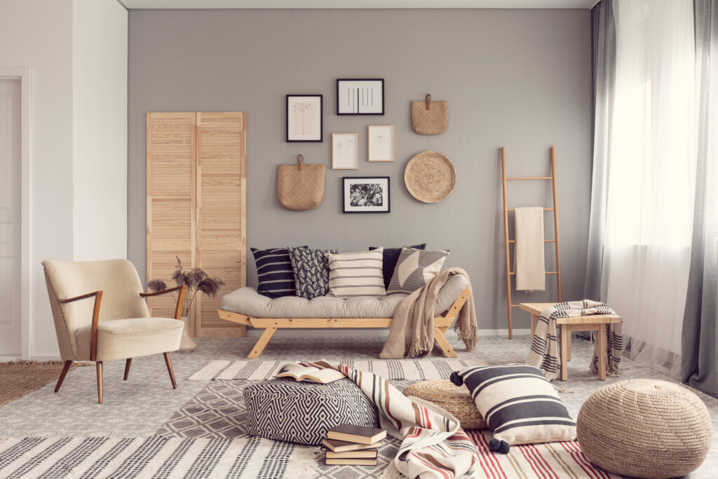 Stylish living room interior design with scandinavian settee, grey accent wall and natural accents