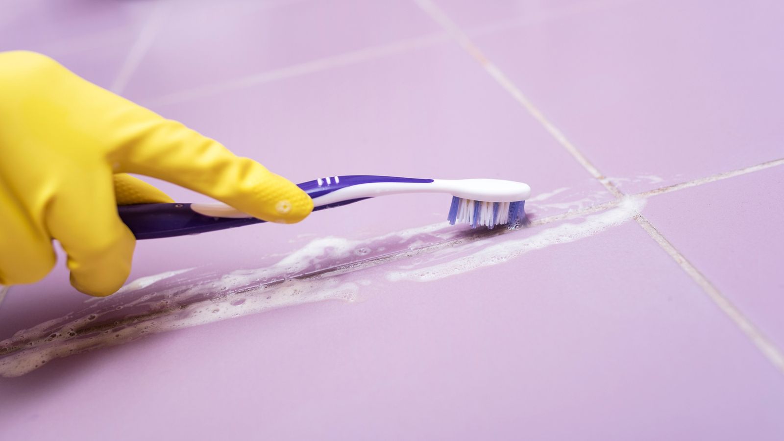 toothbrush scrubbing grout