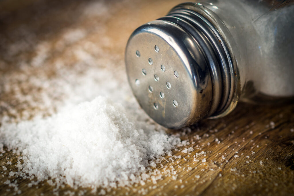 Salt on wooden background