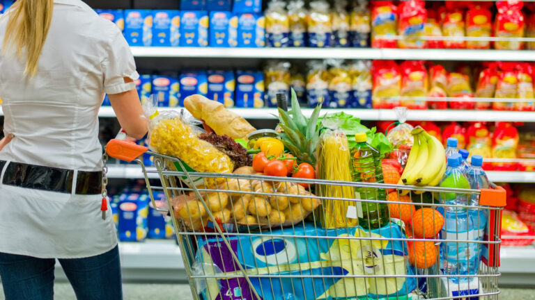a woman is overwhelmed with the wide range in the supermarket when shopping.