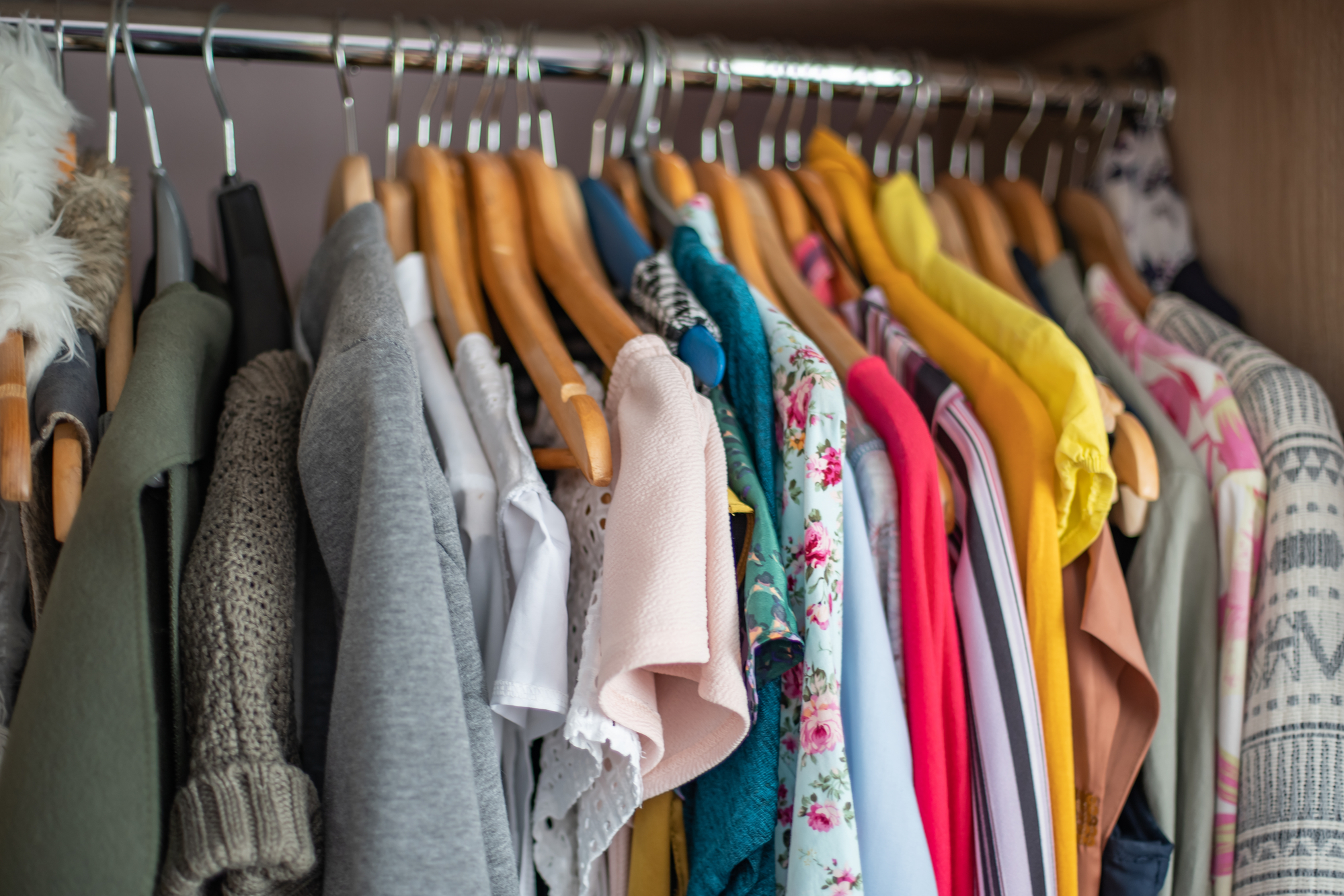 Wardrobe closet full of clothes.