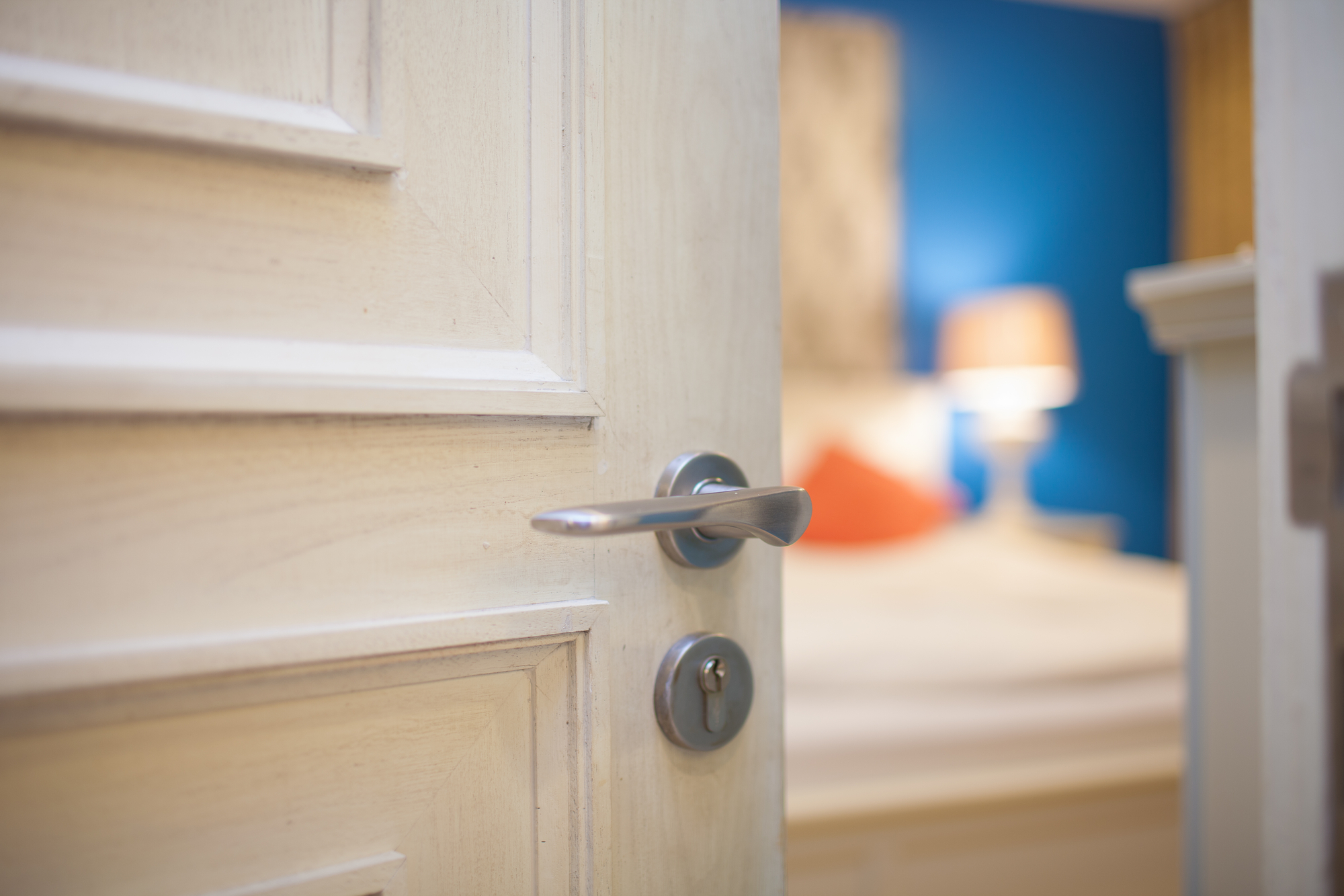 Hand opening the bedroom door for hotel and home concept
