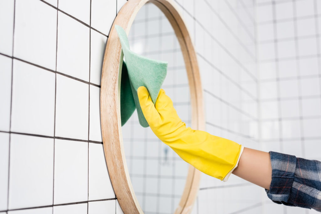 cleaning mirror with gloves