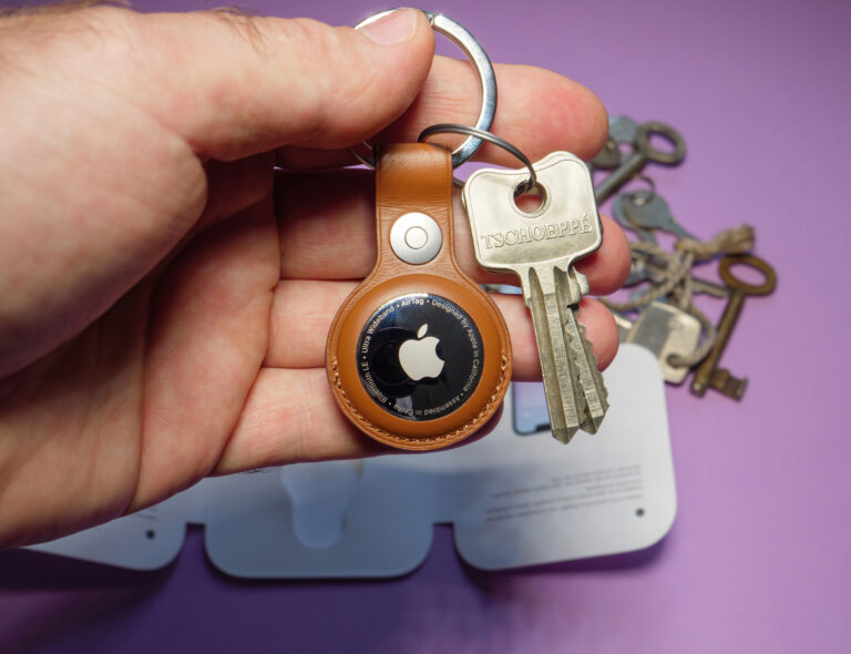 Man showing new AirTag by Apple with keys