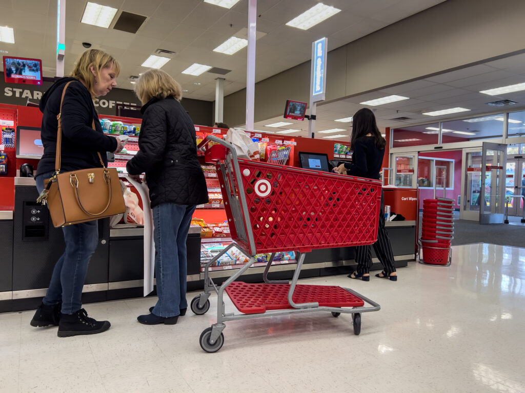 Wide view of people using the self checkout inside a Target retail store.