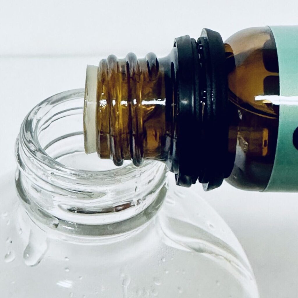pouring essential oil in bottle