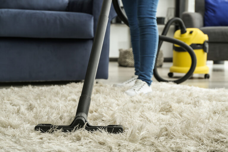 Cleaning of carpet with hoover at home