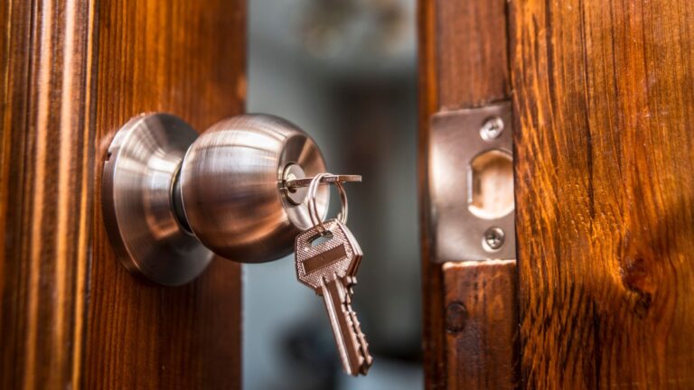 open door, knob and keyhole on wooden door, close up image.