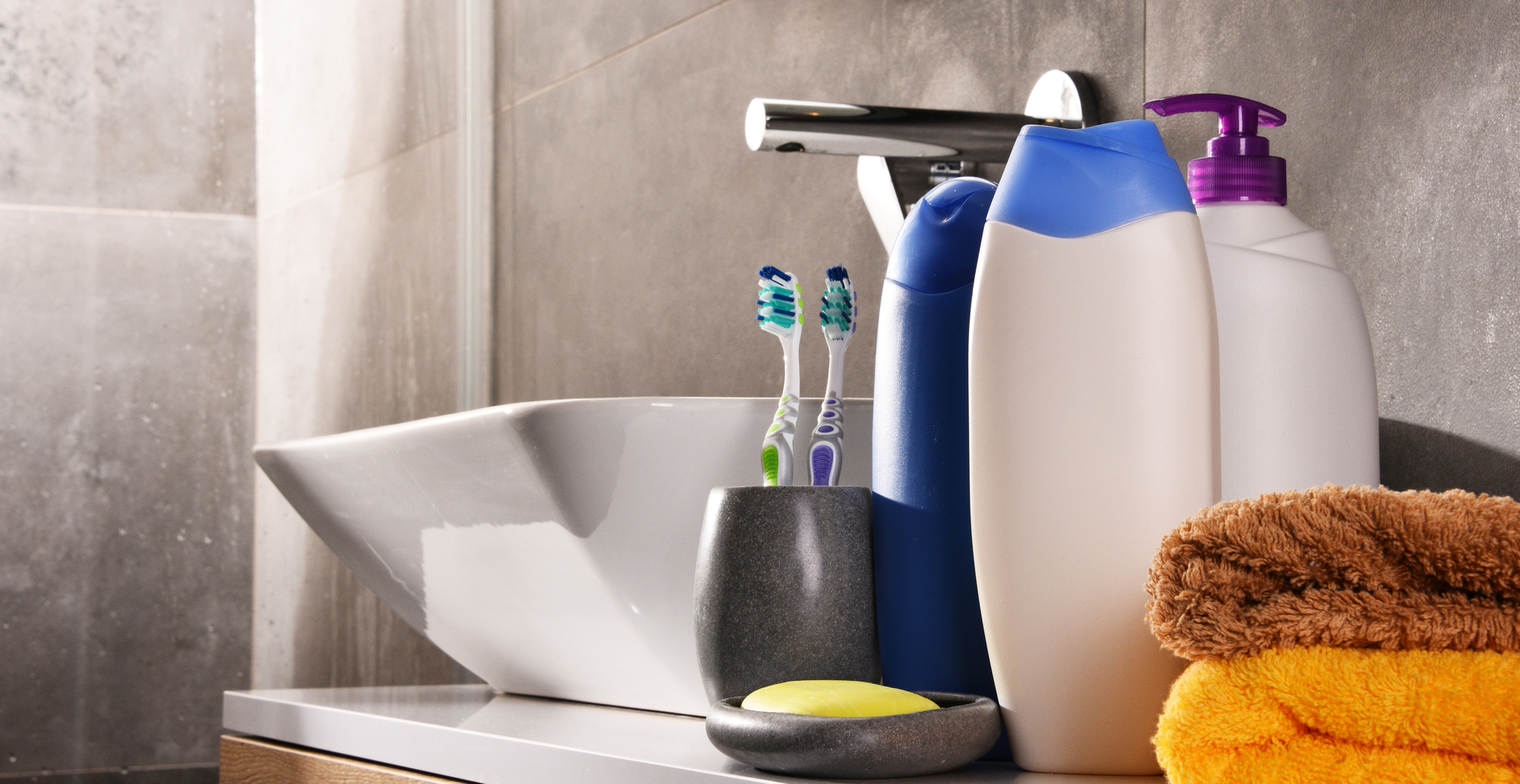 Plastic bottles of body care and beauty products in the bathroom