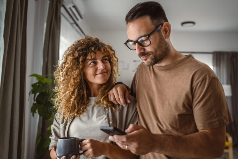 Portrait of adult couple husband and wife use mobile phone