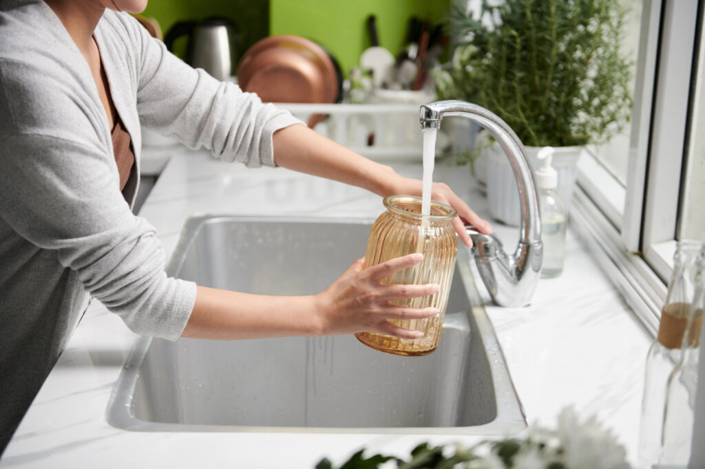 woman filling vase with water 1
