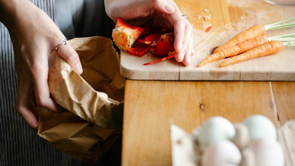 woman cleaning countertop with food