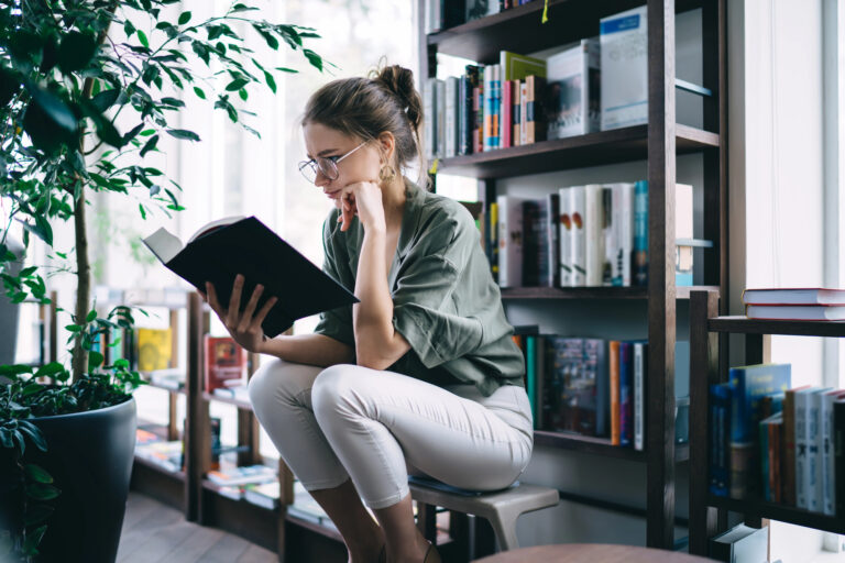 woman in library reading book