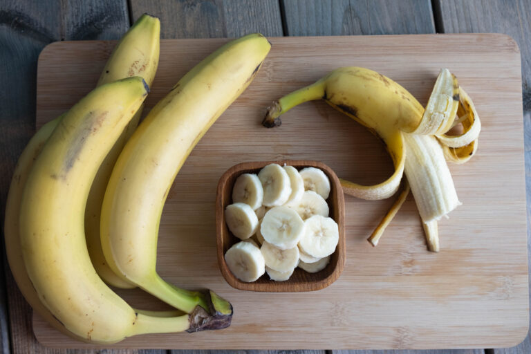 the broken banana lies on a wooden board, and the cut bananas li