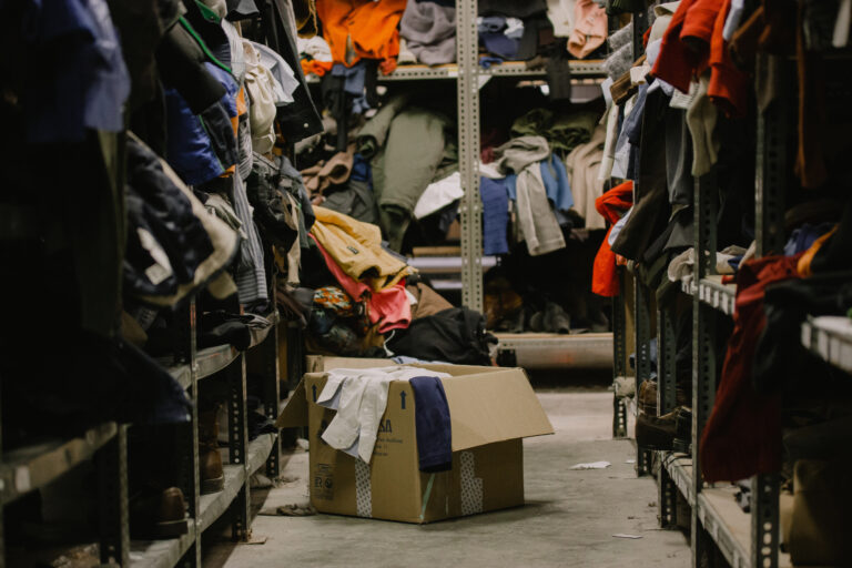 cluttered clothes in closet in box