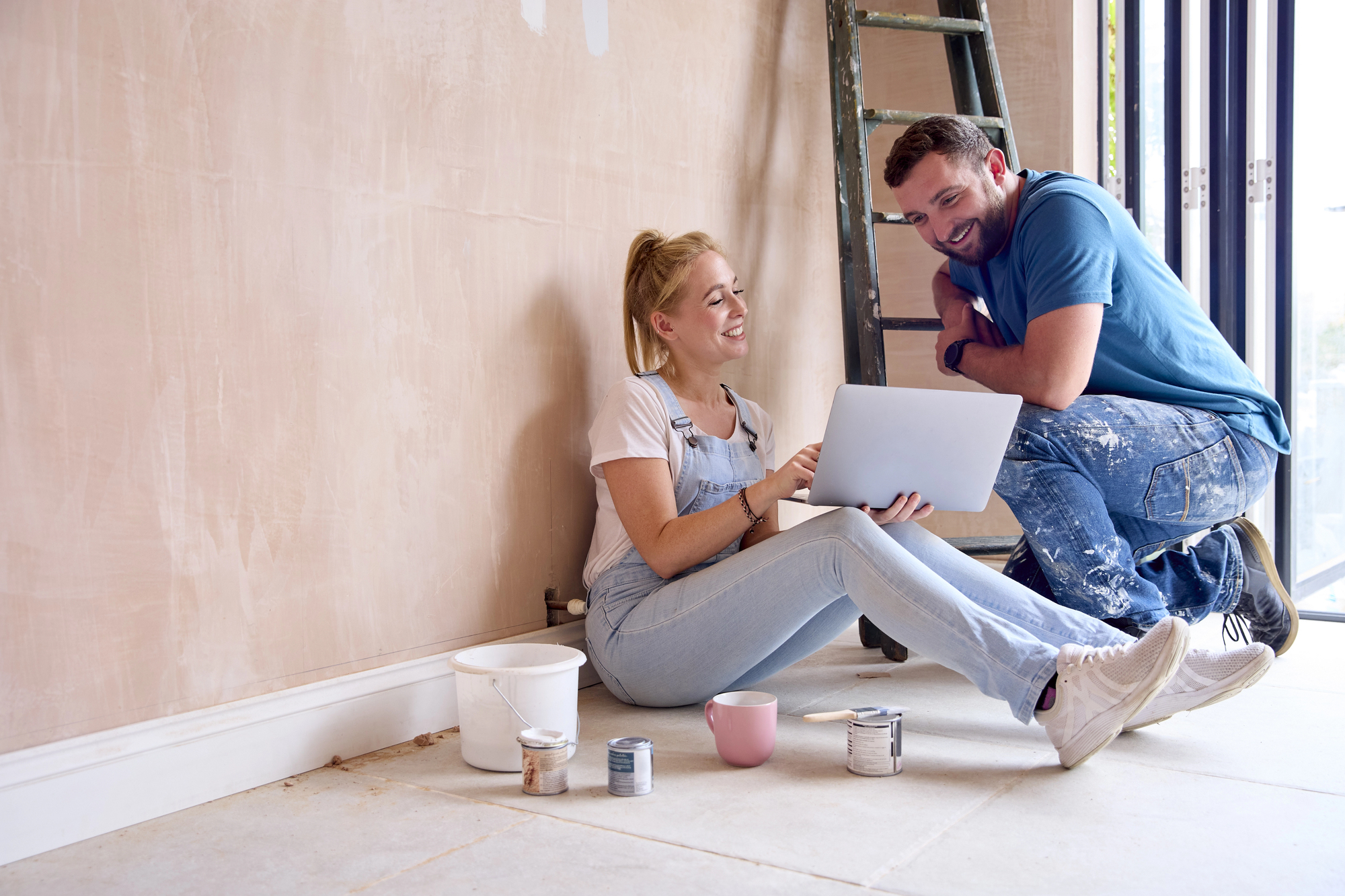 man and woman looking at paint and computer