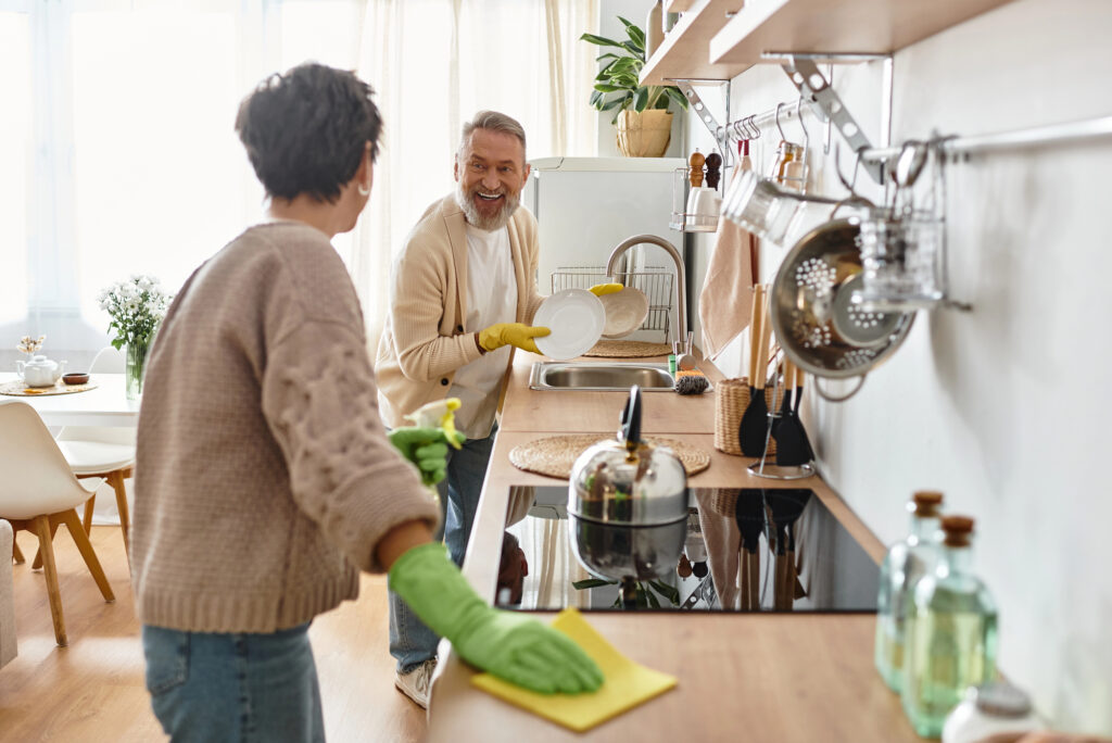 woman and man cleaning kitchen