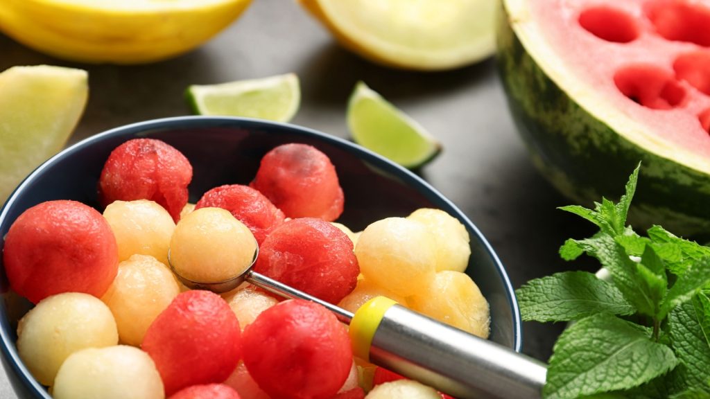 Bowl of melon and watermelon balls with scoop