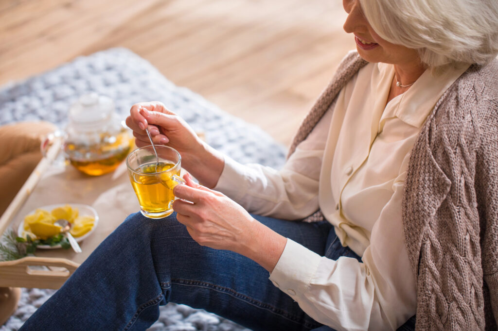 older woman with drinking tea bag 