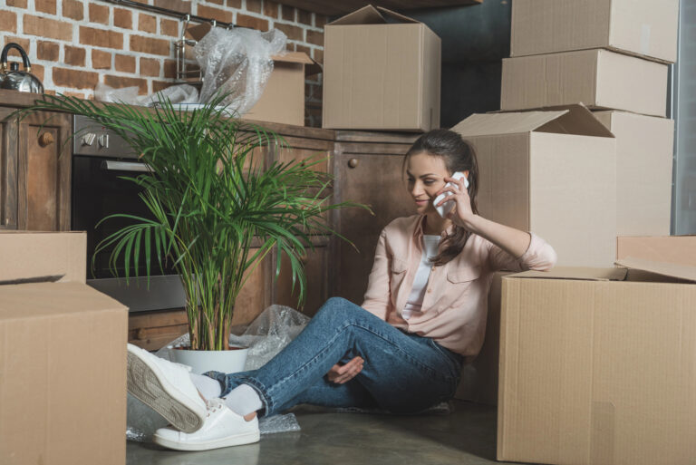woman sitting down on floor with boxes