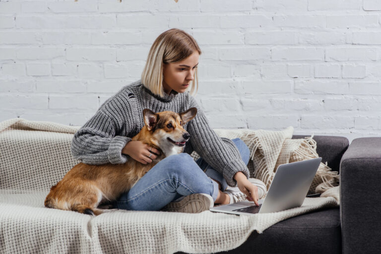 woman holding dog on couch