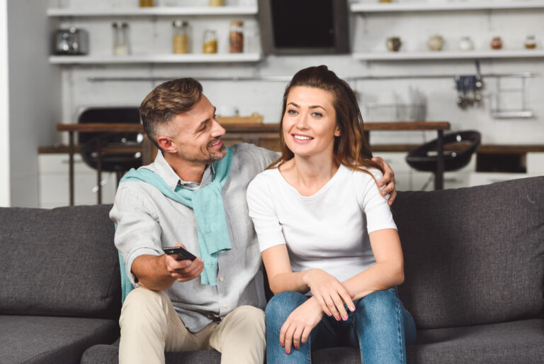 woman and man sitting on a couch