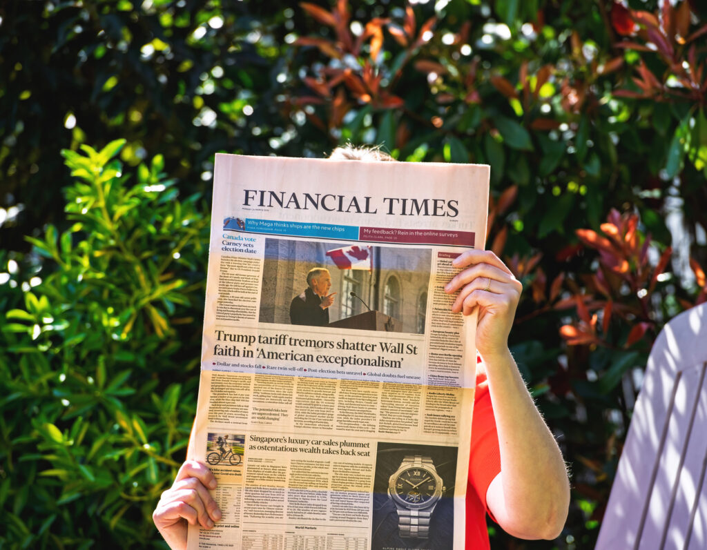 woman holding newspaper with trump