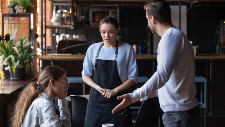 Furious man stand dispute with guilty waitress