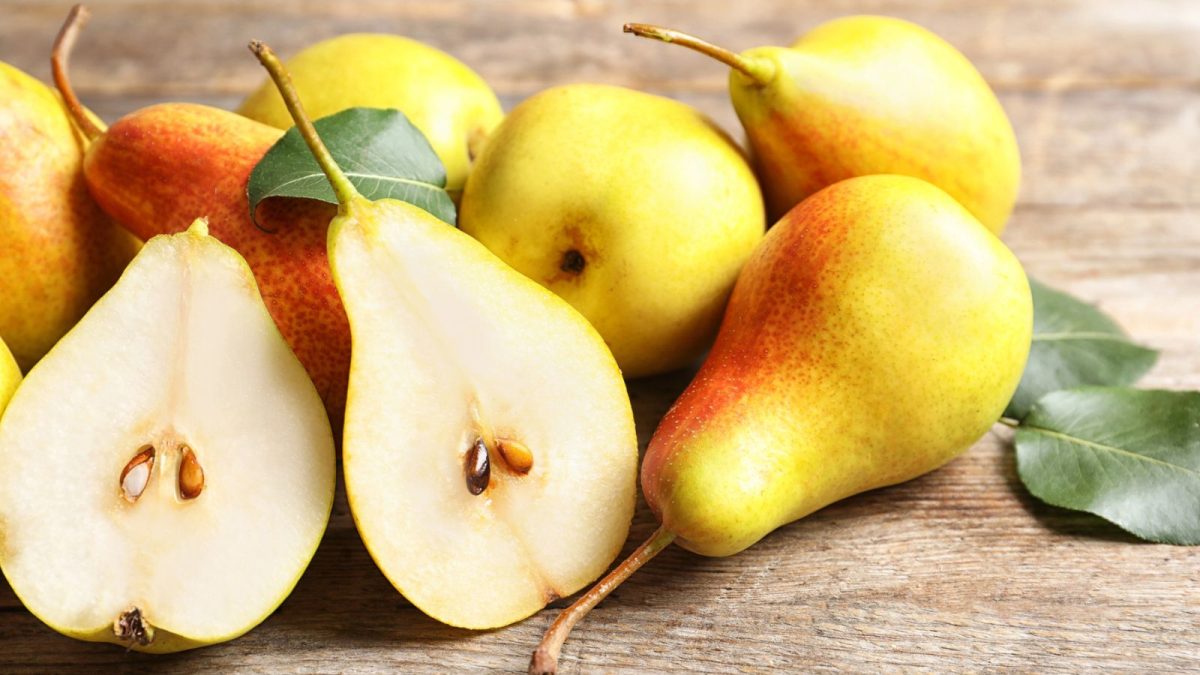 ripe pears on wooden table