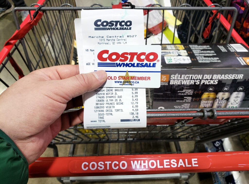 person holding a costco membership and reciept