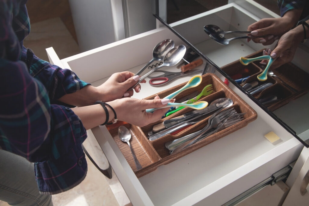 woman in junk drawer in kitchen