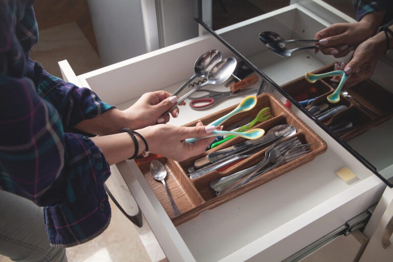 woman in junk drawer in kitchen