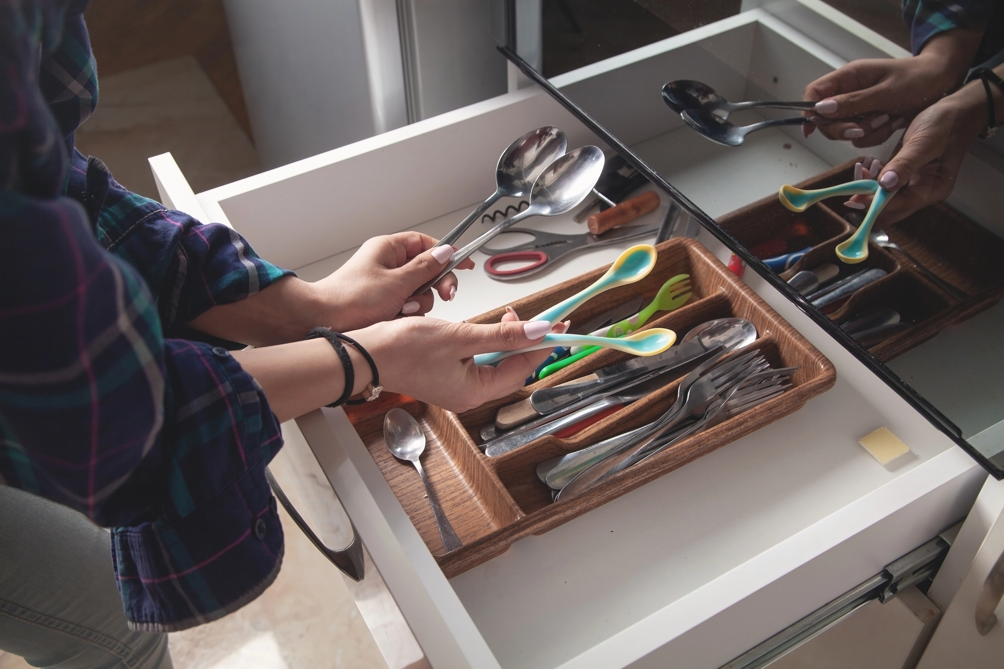 woman in junk drawer in kitchen