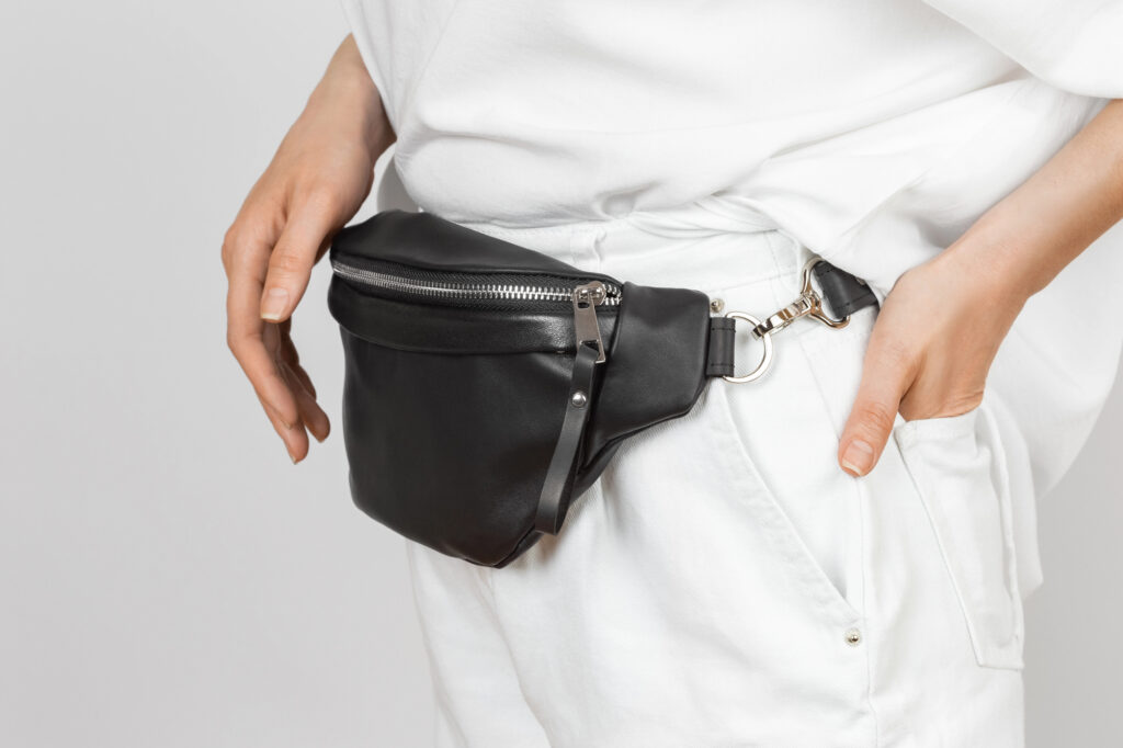 woman in white wearing a fanny pack