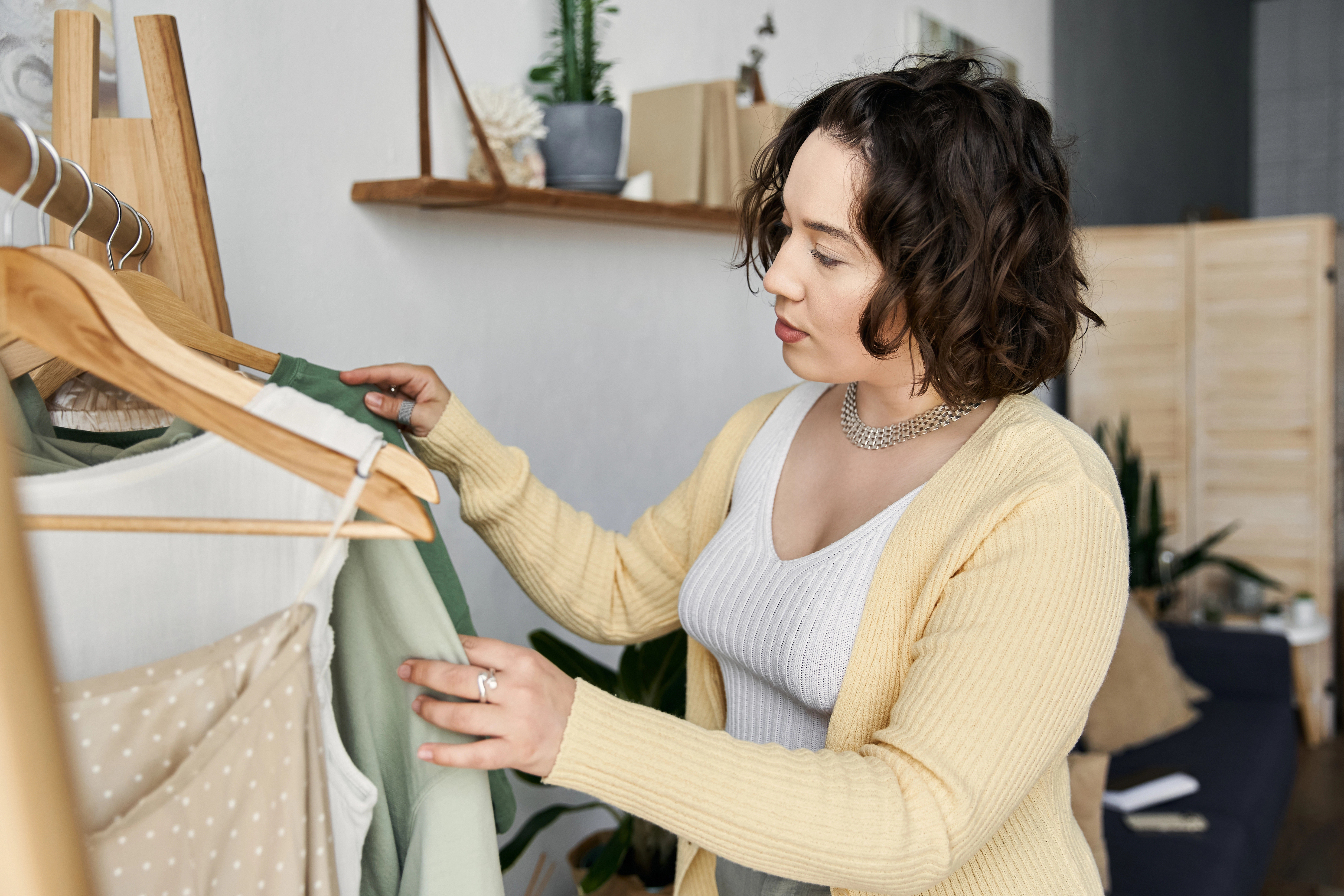 woman going through closet of clothes