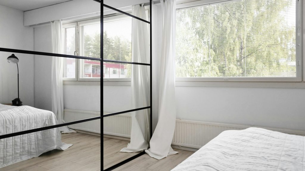Bedroom with Window and Large Mirrors
