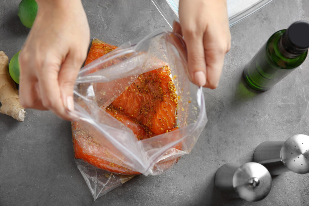 Woman preparing salmon fillet