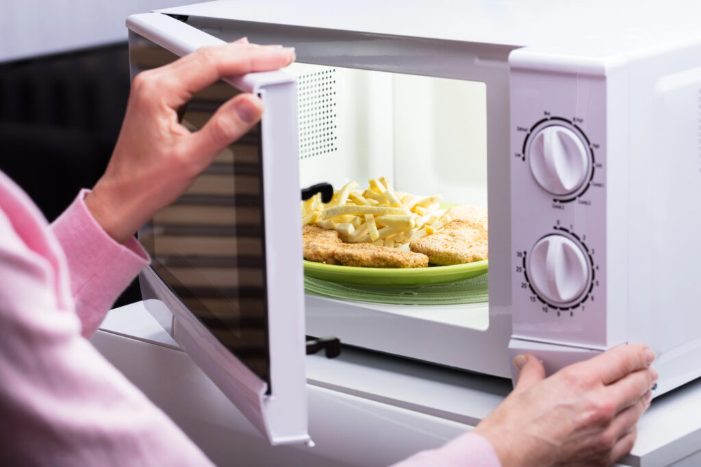 woman opening up microwave