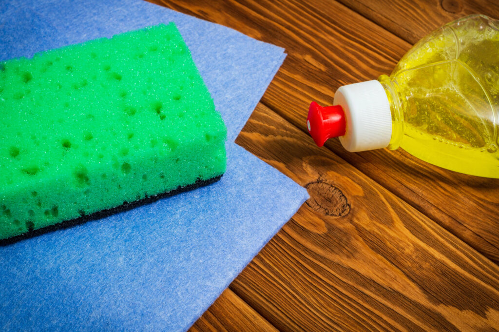 Liquid detergent with pad and towels for cleaning on wooden boards
