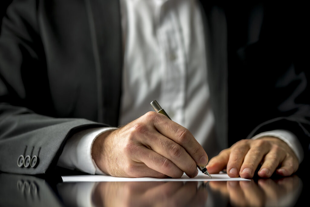 man writing will and testament