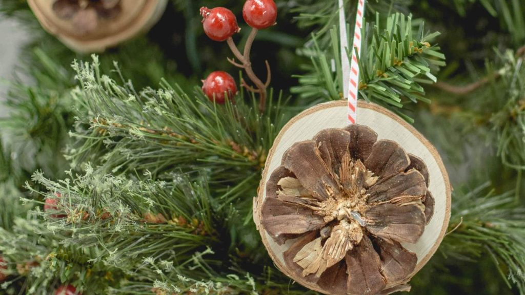 These easy wood slice ornaments are made with pine cones you can collect in your own backyard