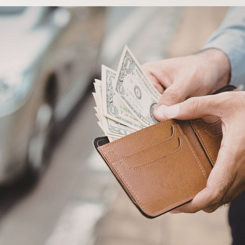 man taking money out of wallet
