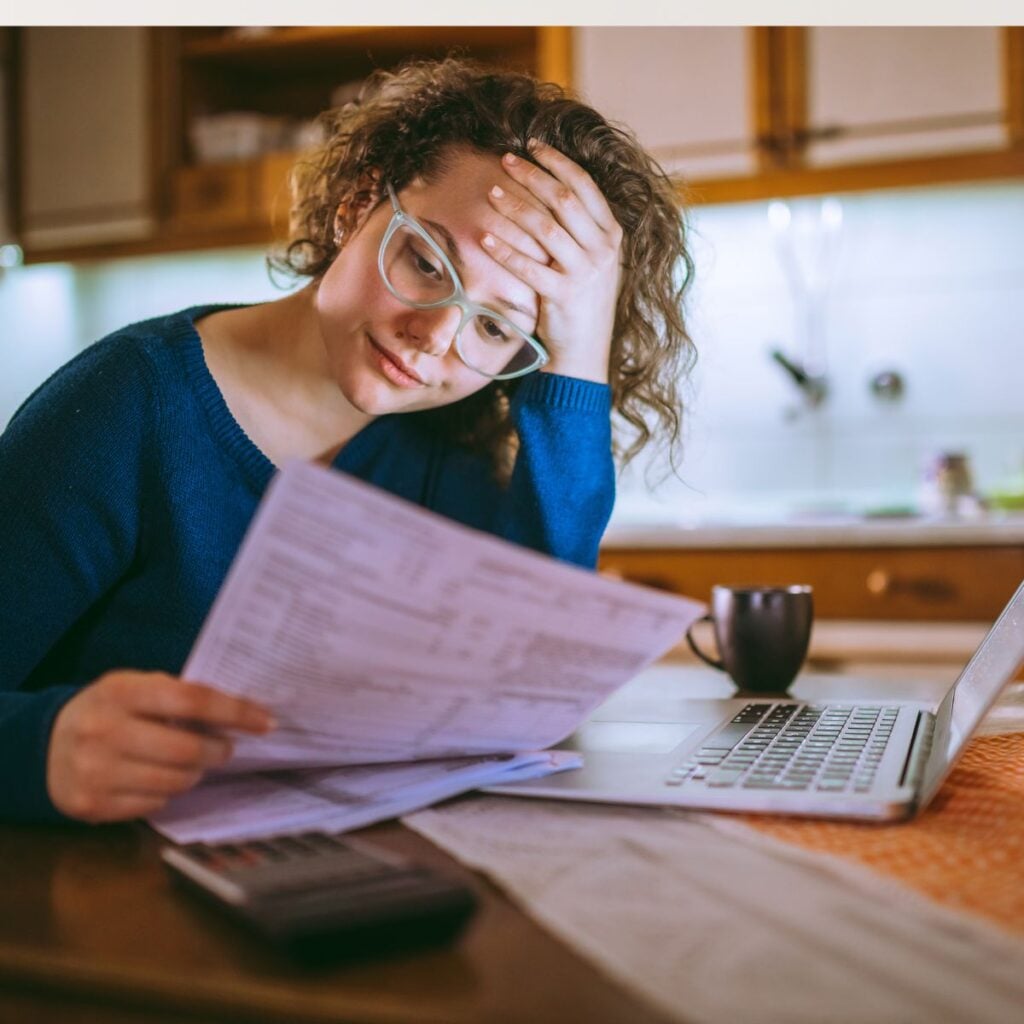girl looking at bills