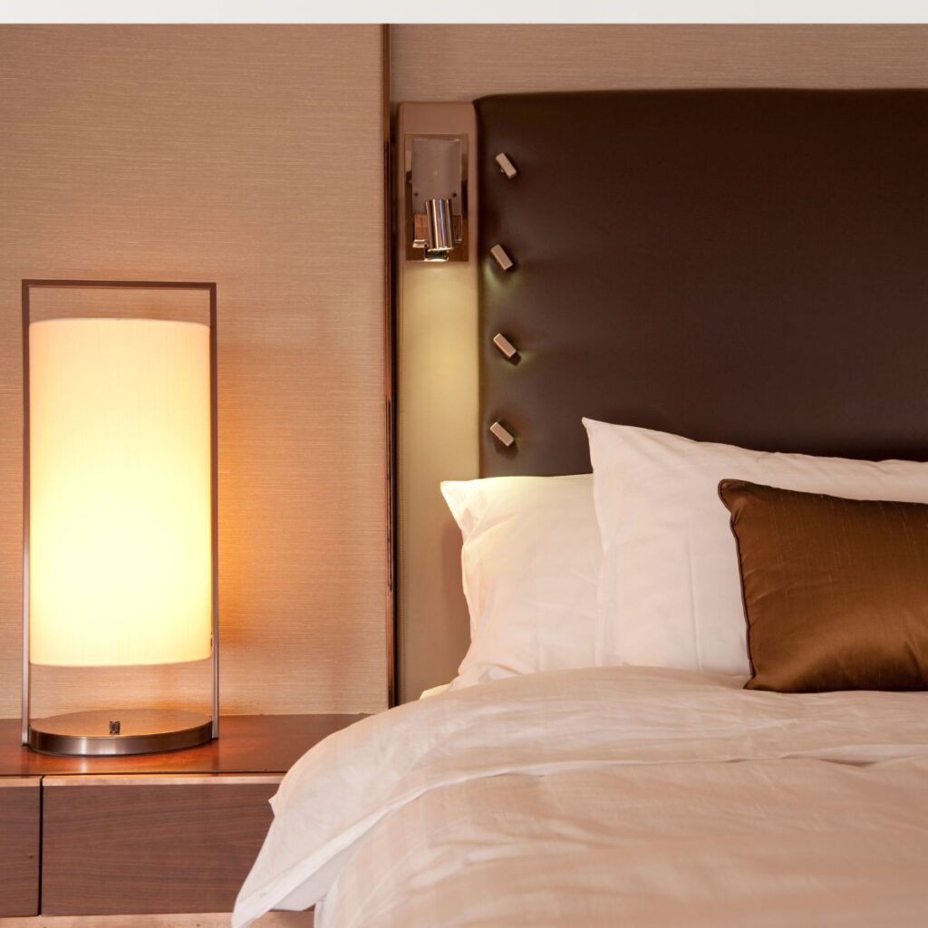 hotel room bed with side lamp