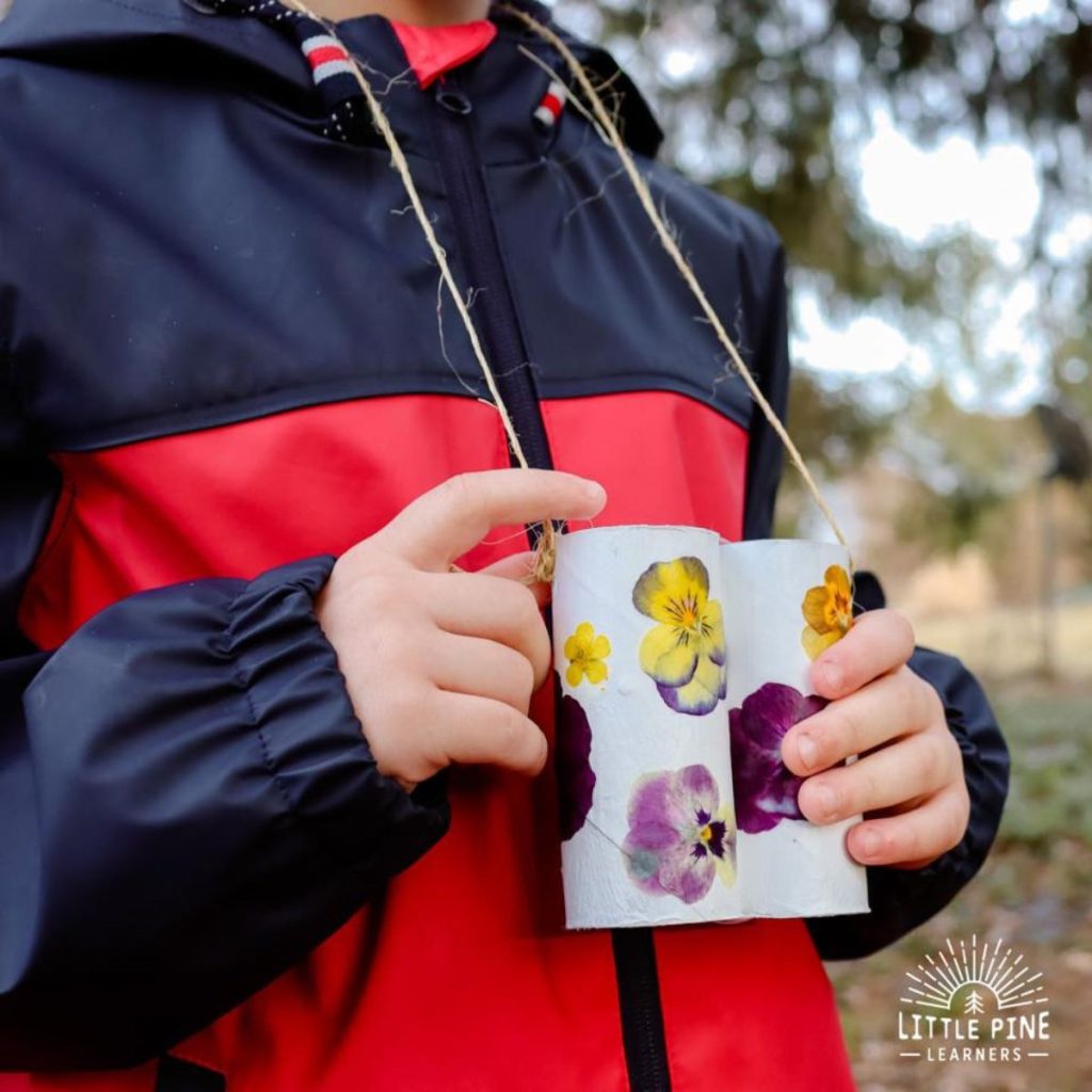 Kid wearing and holding Binoculars with Pressed Flowers
