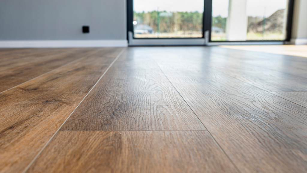 Modern vinyl panels imitating wood in the living room with selective focus and a shadow falling from the window.