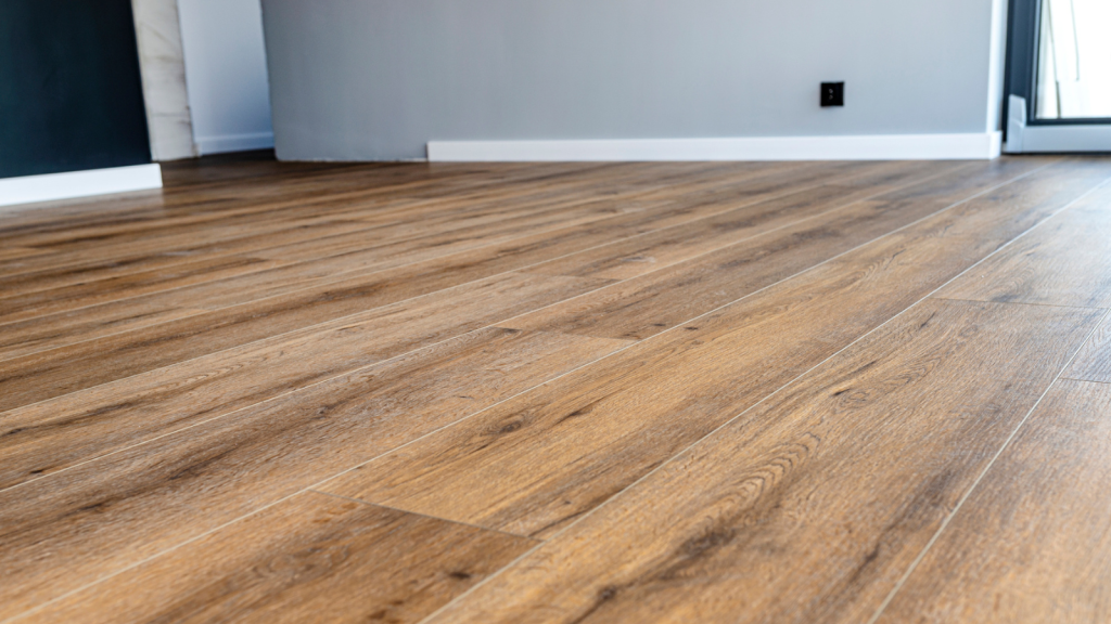 Modern vinyl panels imitating wood in the living room with selective focus and a shadow falling from the window