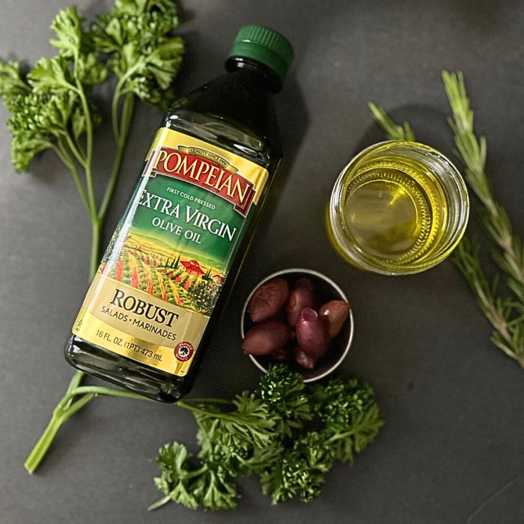 olive oil with olives and mason jar rosemary