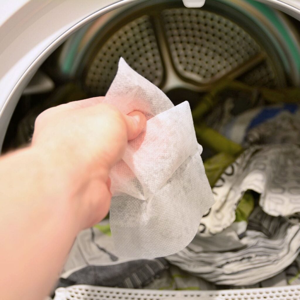 person holding dryer sheets