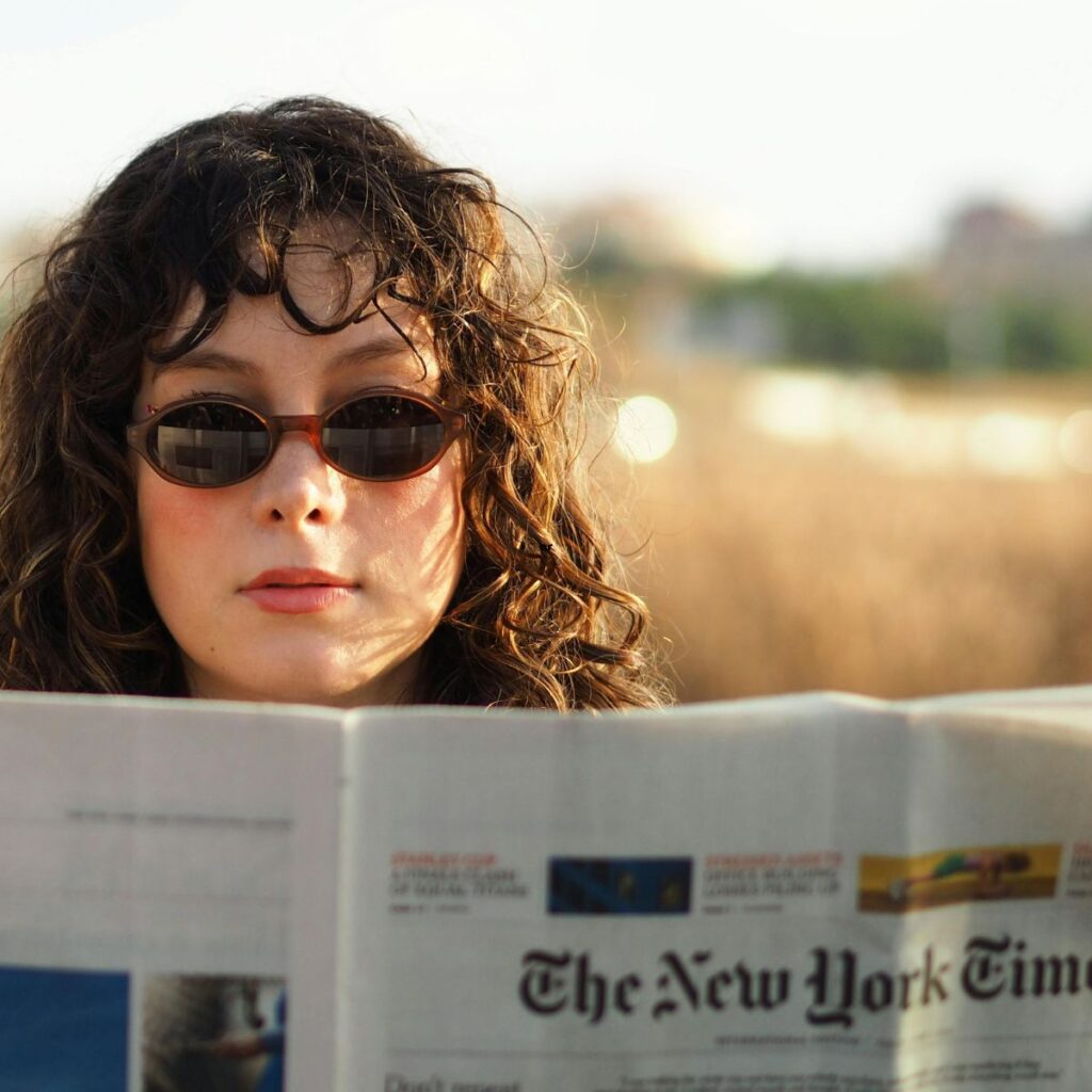 woman reading the new york times